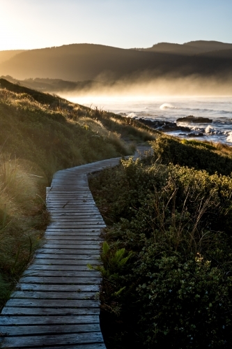 walking path beside the beach at sunrise - Australian Stock Image