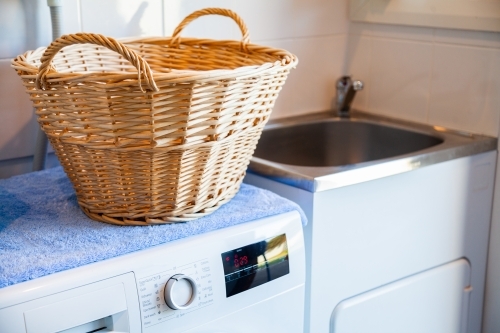 Washing machine in laundry for cleaning clothes - Australian Stock Image