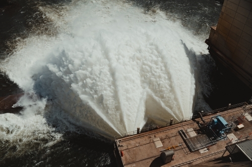 Water flowing from the Hume Dam wall into the Murray River towards Albury. - Australian Stock Image