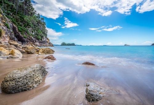 Water running back into the ocean on beautiful white sand beach - Australian Stock Image