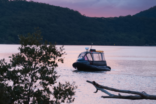 Water taxi at sunsent - Australian Stock Image