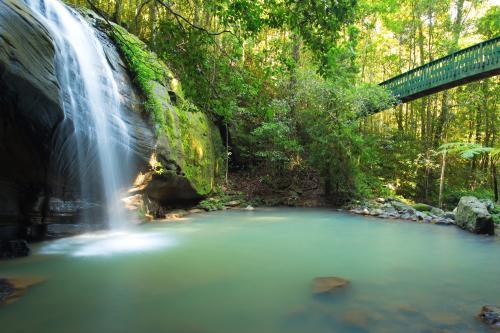 Waterfall and lagoon with bridge across - Australian Stock Image