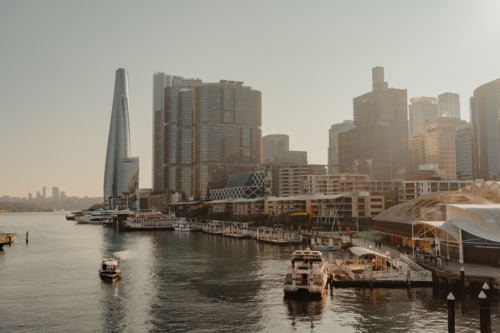 Waterfront city views of Darling Harbour, boats and Barangaroo at sunrise - Australian Stock Image