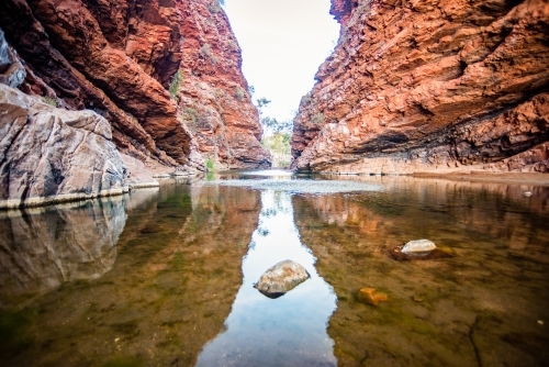 Waterhole showing reflection of rock - Australian Stock Image