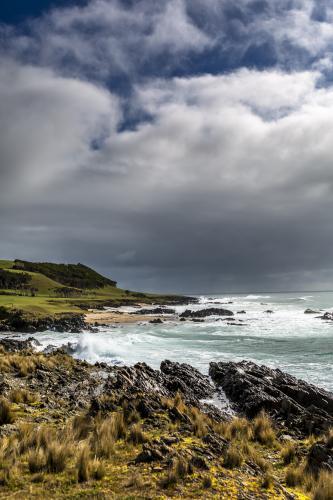 Waves crash into the dramatic King Island Shoreline - Australian Stock Image