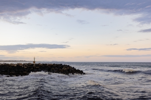 Waves crashing around Northern Break Wall at Brunswick Heads - Australian Stock Image