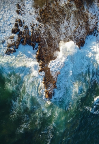 Waves Crashing over Rocks Aerial View