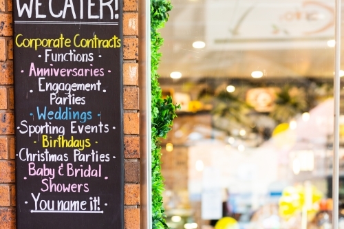 We cater for events sign for catering outside coffee shop window - Australian Stock Image