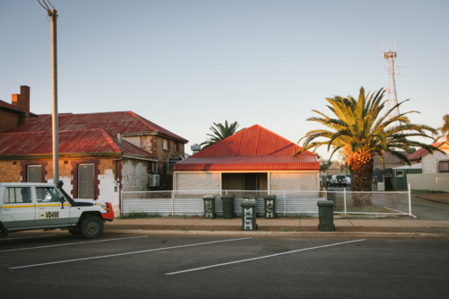 Weather board house and pub at sunset in Cue Western Australia - Australian Stock Image