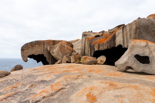 Weathered Granite Boulders with Orange Lichen at Remarkable Rocks, Kangaroo Island - Australian Stock Image