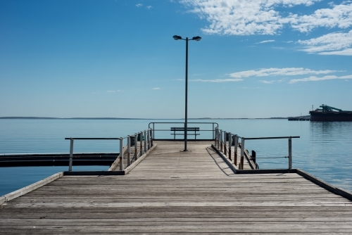 Wharf over still blue water - Australian Stock Image