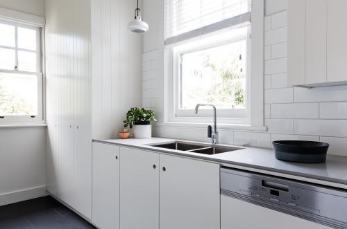 White and charcoal new renovated galley style Australian apartment kitchen