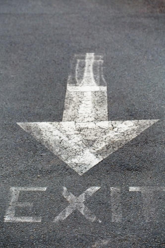 White arrow painted on bitumen road - Australian Stock Image