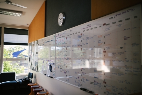 White board planning calendar in a school staff room - Australian Stock Image