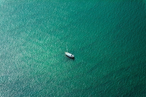 white boat moored in sea green water - Australian Stock Image