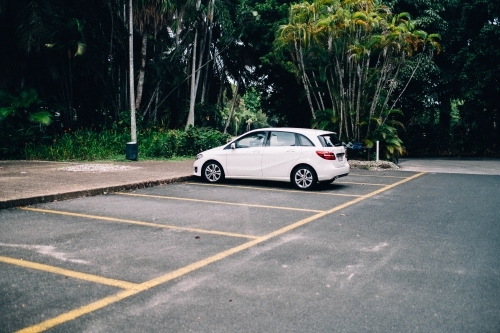 White car parked in empty car park