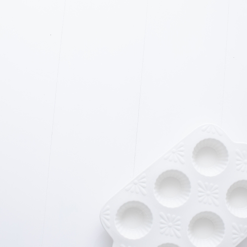 White muffin tray on blank background - Australian Stock Image