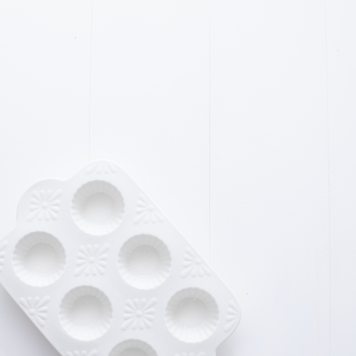 White muffin tray on blank background - Australian Stock Image
