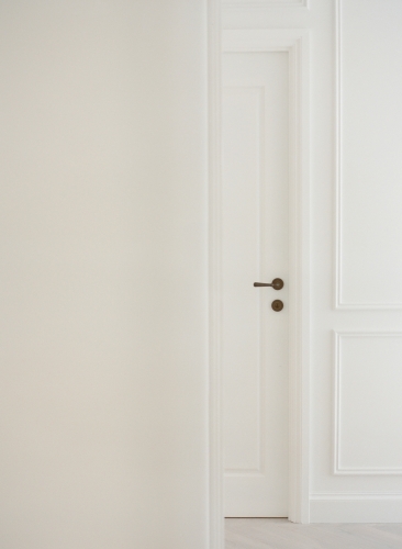 White on white interiors with antique brass door handle details - Australian Stock Image
