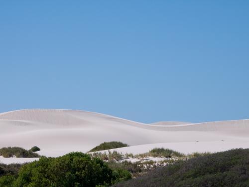 White sand dune with a big clear blue sky - Australian Stock Image