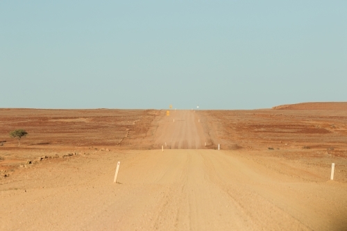 Wide outback dirt road with blue sky - Australian Stock Image
