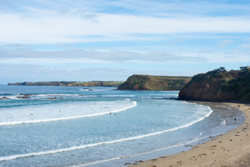 Wide shot of surf beach and cliffs - Australian Stock Image