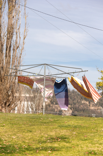 Wind blowing towels on hills hoist with Snowy Hydro in the background - Australian Stock Image