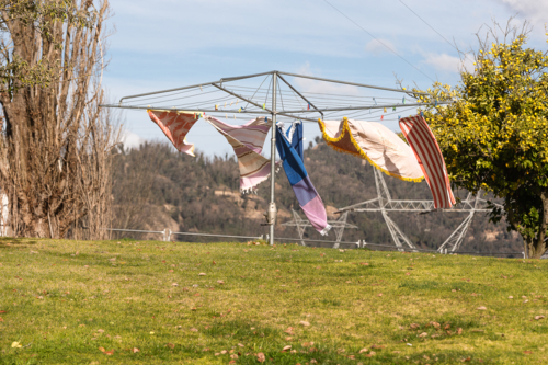 Wind blowing towels on hills hoist with Snowy Hydro in the background - Australian Stock Image