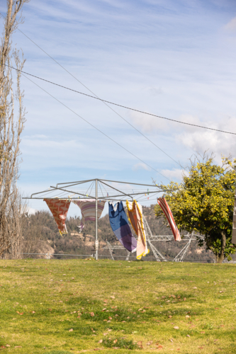 Wind blowing towels on hills hoist with Snowy Hydro in the background - Australian Stock Image