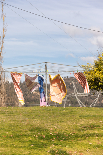 Wind blowing towels on hills hoist with Snowy Hydro in the background - Australian Stock Image