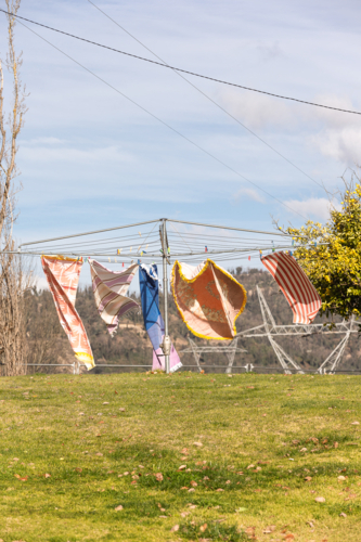 Wind blowing towels on hills hoist with Snowy Hydro in the background - Australian Stock Image