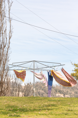 Wind blowing towels on hills hoist with Snowy Hydro in the background - Australian Stock Image