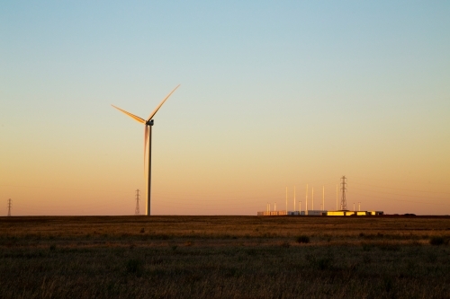 Wind turbine and battery at dusk - Australian Stock Image