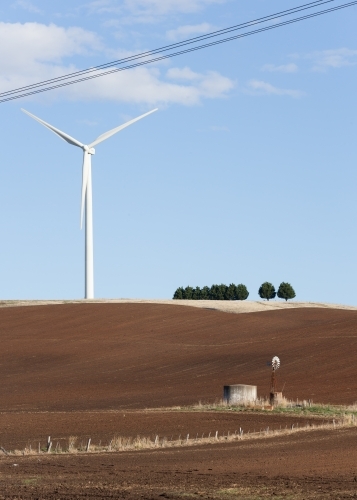 Wind turbine in paddock with windmill in foreground - Australian Stock Image