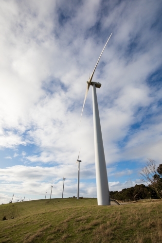 Wind turbines on a bare grassy hill exposed to offshore winds on the Fleurieu Peninsula - Australian Stock Image