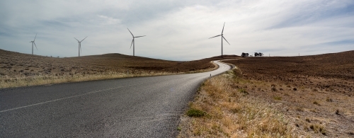 Wind turbines on windy road