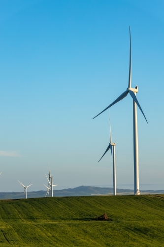 wind turbines with farmland in foreground, vertical - Australian Stock Image