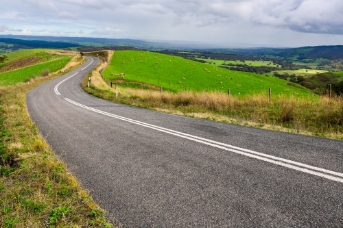 Winding road through Adelaide Hills farms during winter season. - Australian Stock Image