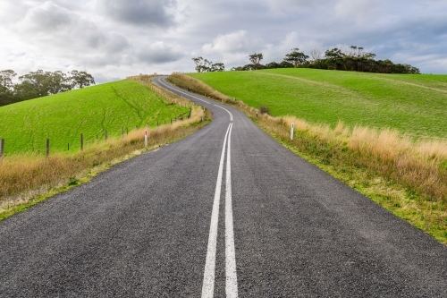 Winding road through Adelaide Hills farms during winter season. - Australian Stock Image