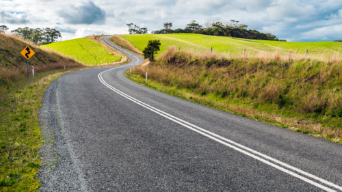 Winding road through Adelaide Hills farms during winter season - Australian Stock Image