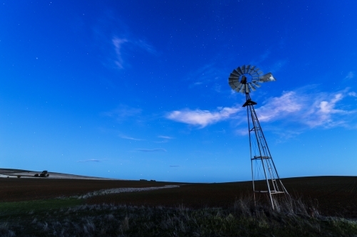 Windmill against a blue night sky - Australian Stock Image