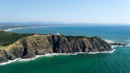 Windswept headland above rugged coastline with steep cliffs - Australian Stock Image