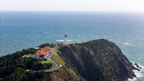 Windswept headland above rugged coastline with steep cliffs - Australian Stock Image