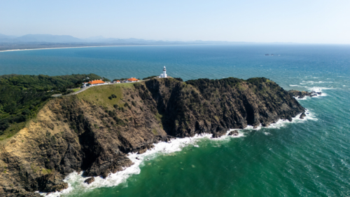 Windswept headland above rugged coastline with steep cliffs. - Australian Stock Image