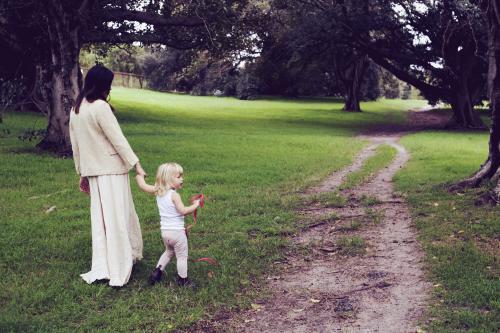 Woman and young child standing by dirt track - Australian Stock Image