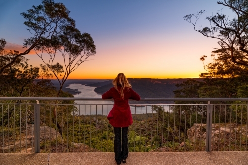 Woman at lookout watching the sunset at Burragorang, Nattai Australia - Australian Stock Image