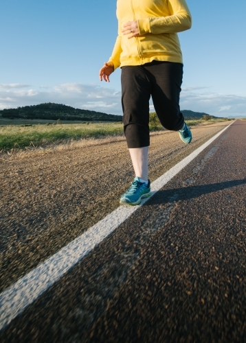 Woman doing exercise on a remote country road