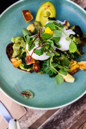 woman eating breakfast in cafe - Australian Stock Image