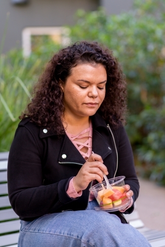 woman eating fruit salad