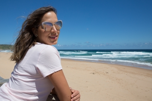 Woman enjoying summer sun at the beach - Australian Stock Image